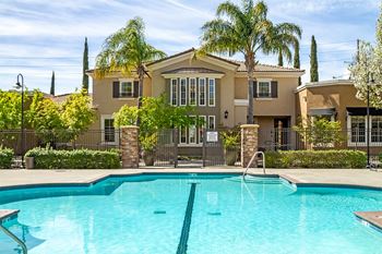 Dazzling pool area with private cabanas, comfy lounger chairs, and seating for all